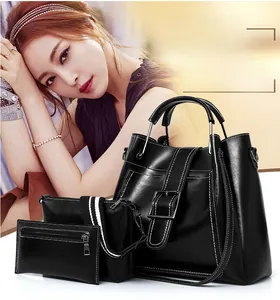 Detailed view of black PU leather 3-piece tote set with white contrast stitching