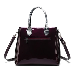 Deep purple faux crocodile leather handbag with snake print handles and golden hardware