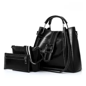 Midnight black three-piece handbag set featuring glossy leather and white contrast stitching