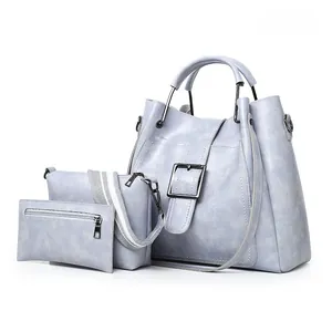 Detailed view of three-piece Smoke Grey faux leather handbag set with metal buckles