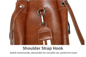 Detail of silver D-ring and lobster clasp on striped detachable bag shoulder strap