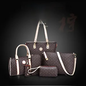 Detail of elegant dark brown 6-piece handbag set with geometric print and gold hardware