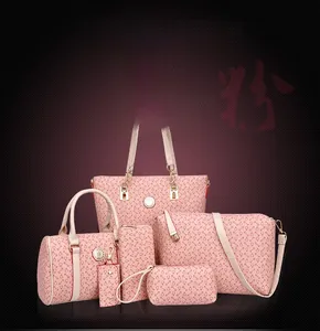Detail view of pink 6-piece handbag set with textured pattern and gold hardware accents