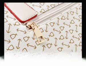 Close-up of smooth gold zipper hardware on printed pebble leather handbag set