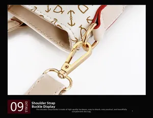 Macro shot of gold metal swivel buckle on leather bag with pattern and red edge finish