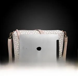 Size comparison of beige printed crossbody bag next to an iPad for scale