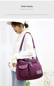 Detailed view of a purple multi-pocket waterproof nylon crossbody bag worn by a model