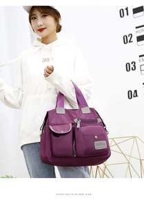 Detailed view of purple waterproof oxford nylon handbag with multiple functional pockets