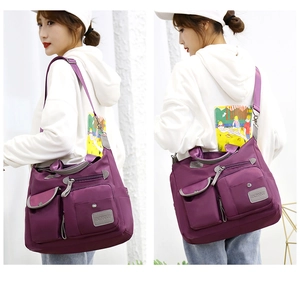 Detail view of purple waterproof oxford fabric shoulder bag with multi-pocket design