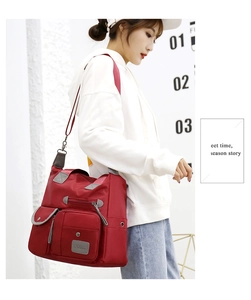 Detail view of red waterproof oxford fabric multi-pocket shoulder bag with zippers