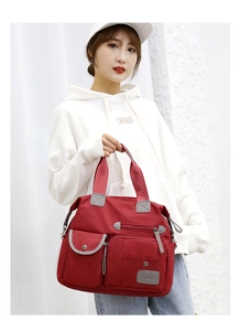 Detailed view of red large capacity oxford cloth crossbody bag with multiple pockets