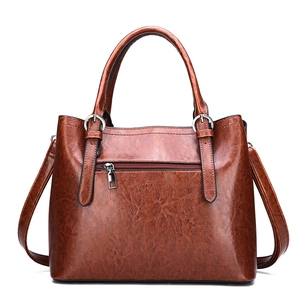 Fashionable brown glossy patent leather tote bag with top handles and adjustable strap