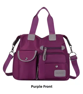 Front view of purple oxford crossbody bag with multiple zippers and pockets for travel