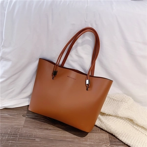 Minimalist brown faux leather tote bag for women with Forever Young logo and thin straps
