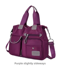 Detail view of purple waterproof oxford nylon bag with multiple zipper pockets