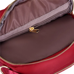 Modern red waterproof oxford shoulder bag featuring organized interior zipper pocket