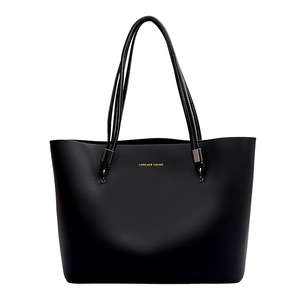 Minimalist black leather tote bag with Forever Young gold text and slim top handles