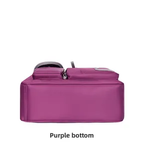 Detail view of the waterproof oxford fabric bottom and side zip pockets on the purple bag