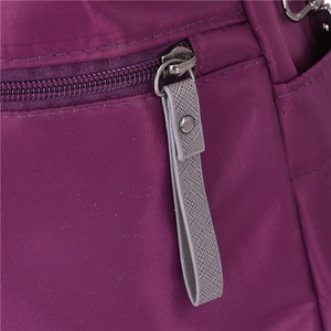 Macro view of waterproof nylon fabric with metal zipper and leather pull on travel bag