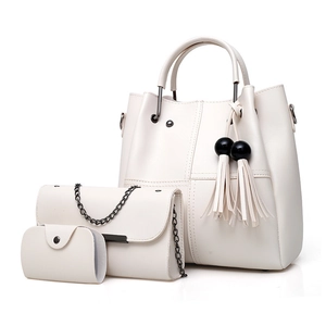 Three-piece beige faux leather handbag set with tote, chain bag, and pompom tassel