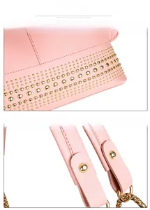 Detail von rosa Handtasche mit goldenen Bodennieten und verstärkten Tragegriffen aus Leder