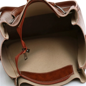 Three-piece leather handbag set featuring brown PU material and spacious interior zip pockets