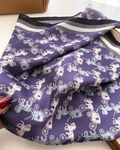 Macro detail of purple silk scarf featuring horse carriage print and striped edges