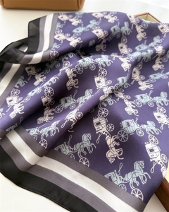Detailed view of dark purple silk scarf with horse carriage print and satin finish texture