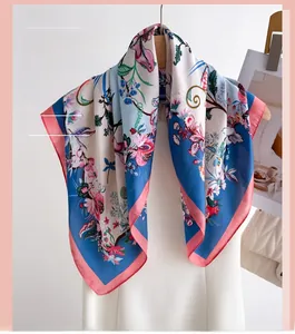 Close-up of floral silk scarf with pink borders and sky blue botanical pattern