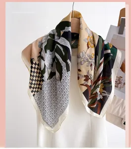 Detailed pattern of silk scarf featuring green palm leaves and yellow floral designs