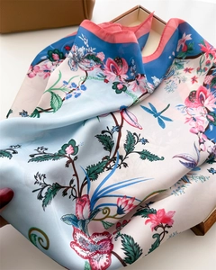 Detail of floral silk scarf with pink roses, blue dragonfly and coral pink hem edges