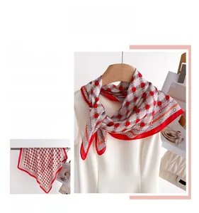 Detail of red and white silk scarf with geometric H-chain pattern and smooth texture