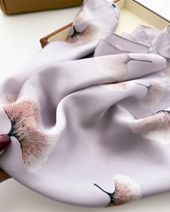 Detail of light purple silk scarf featuring elegant ginkgo leaf patterns and soft texture