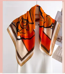 Close-up of geometric floral silk scarf with abstract roses and orange color blocks