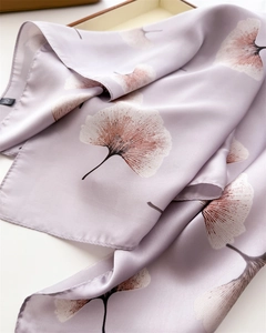 Detail of silk-like satin scarf with ginkgo leaf pattern and smooth machine-hemmed edges