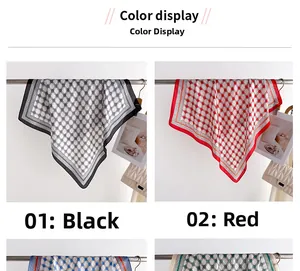 Detail view of red and black geometric plaid scarves hanging on a minimalist metal rack