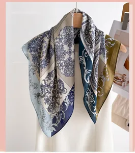 Close-up of olive green and navy retro baroque print silk scarf hanging on a wooden hanger