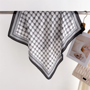 Detail of soft silk square scarf with geometric chain prints and black borders