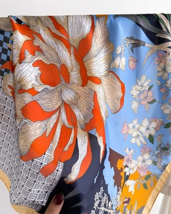 Close-up of artistic floral print silk scarf with fine hand-rolled edges and vibrant colors