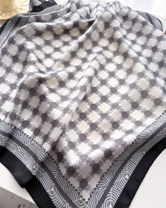 Detail of grey and beige chain pattern silk scarf with elegant geometric wave borders