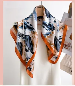 Detail of elegant square scarf with colorful abstract print hanging on a wooden hanger