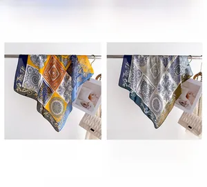 Detail view of vintage printed silk scarves in yellow-blue and navy coffee patterns