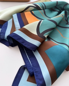 Detail of silk scarf showing geometric abstract prints and smooth lustrous texture