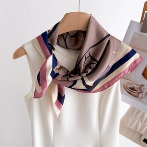 Ink floral geometric silk scarf in dusty pink and navy, tied on a white sleeveless dress