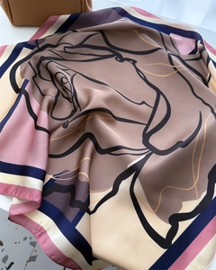 Detailed view of the silky floral scarf with elegant rose patterns and smooth texture