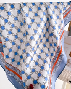 Detail of silk scarf showing geometric chain patterns and orange decorative borders