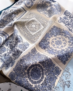 Detailed macro of smooth satin scarf with blue baroque floral pattern and glossy texture