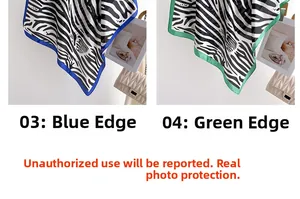 Detailed view of fashionable zebra print silk scarves with blue and green border edges