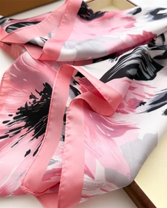 Detailed view of floral satin square scarf with elegant black patterns on white and pink silk