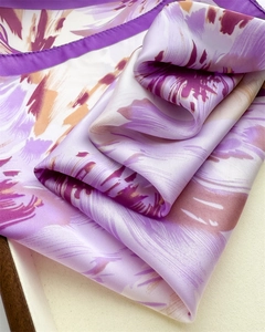Detailed view of lavender floral silk scarf texture with elegant satin border and high sheen